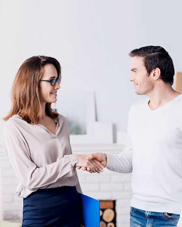a female psychologist and a male client doing a hand shake