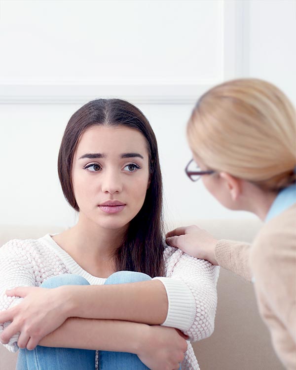 a team member and a female client during a psychotherapy
