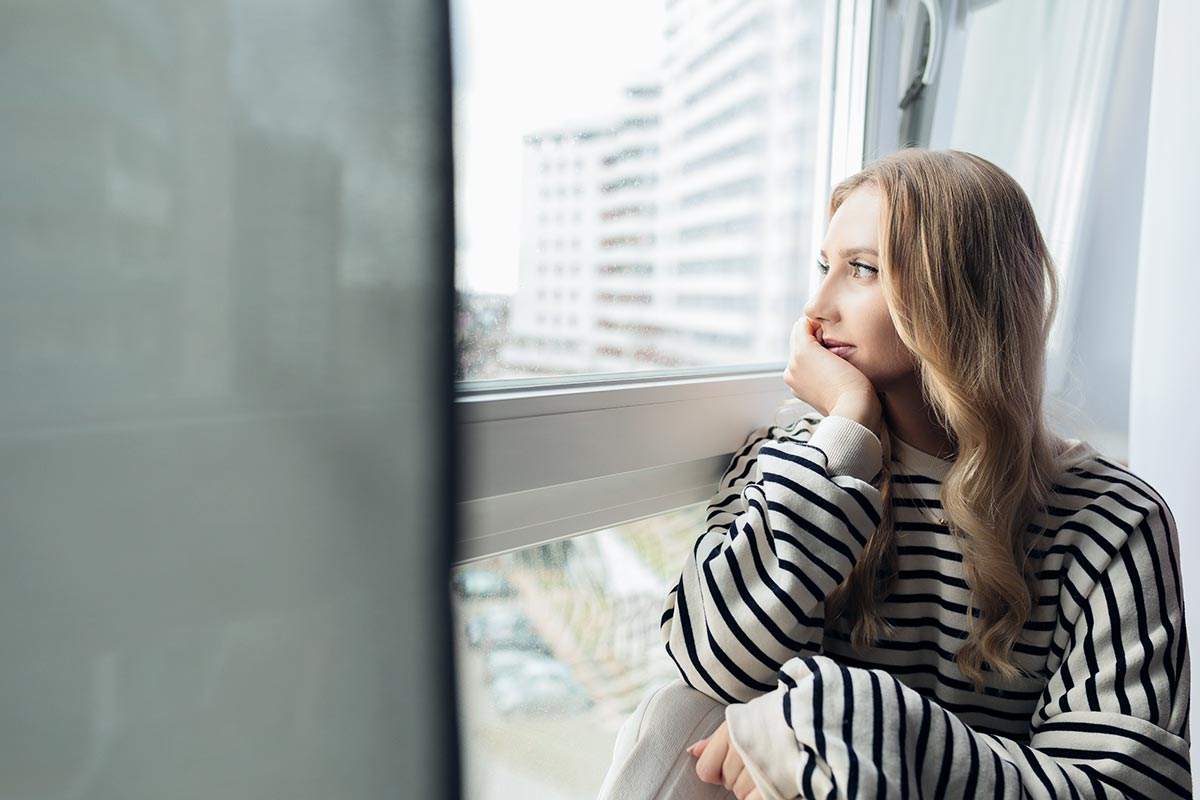 a thoughtful female looking outside the window Co-Occurring Disorders Increase Risk of Relapse