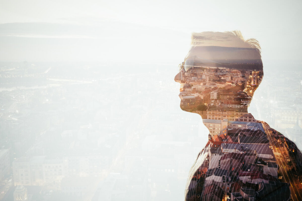 A side profile of a man looking outward with an overlay of a distorted world, symbolizing complex trauma and dissociation as he struggles to align with reality.