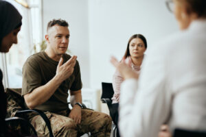 Military veteran participates in outpatient psychiatric treatment during group therapy at Redeemed Mental Health in Newport Beach