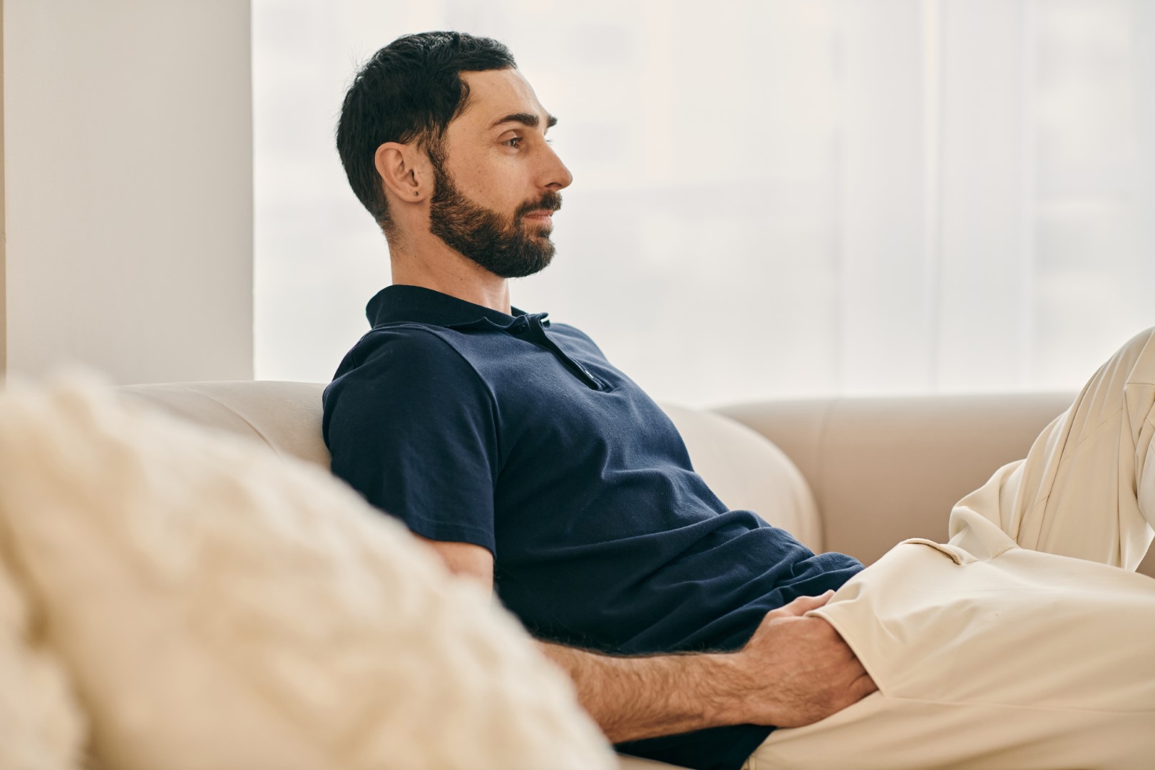 Man resting peacefully on a sofa during a quiet moment of reflection
