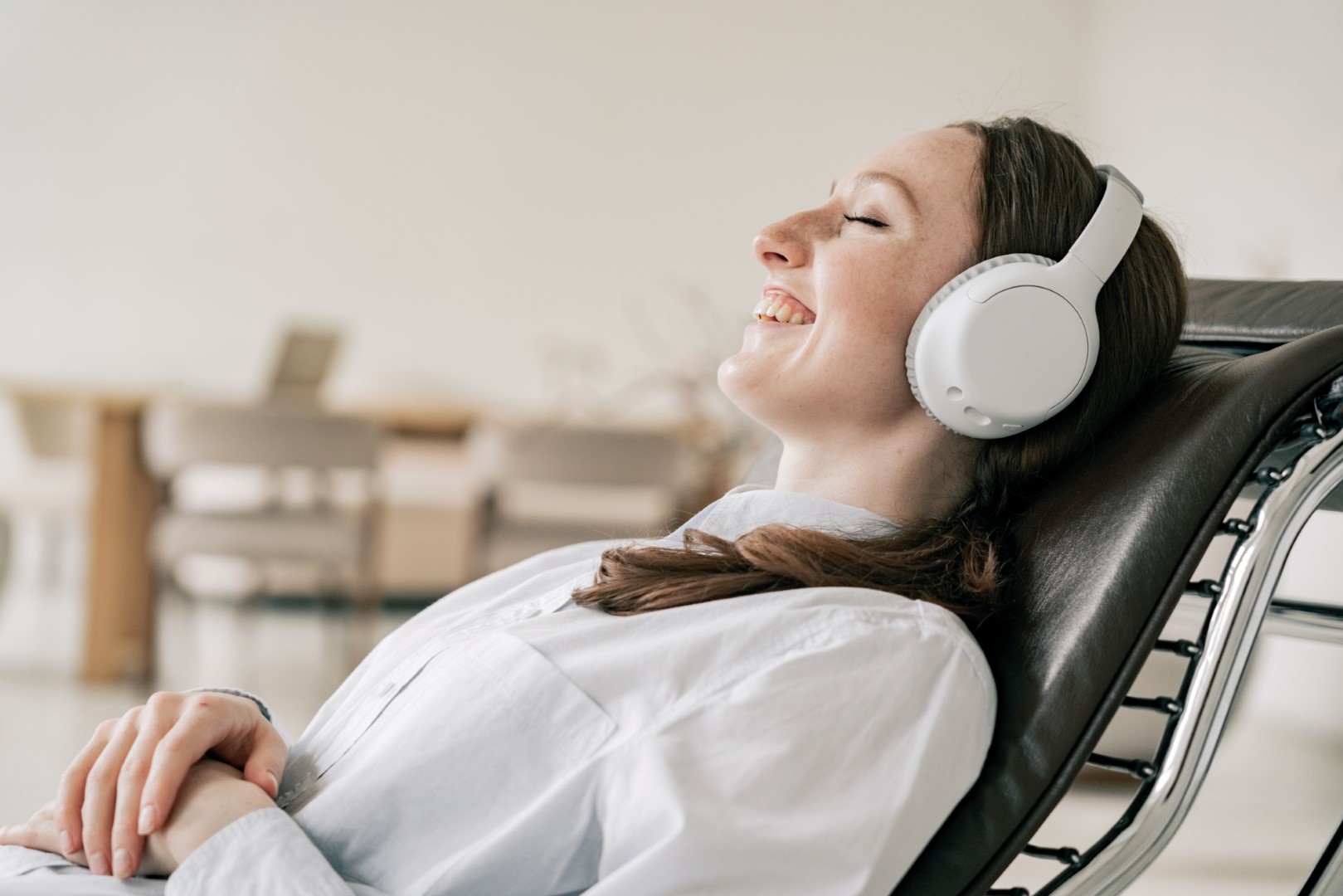 Woman relaxing in a chair while listening to headphones