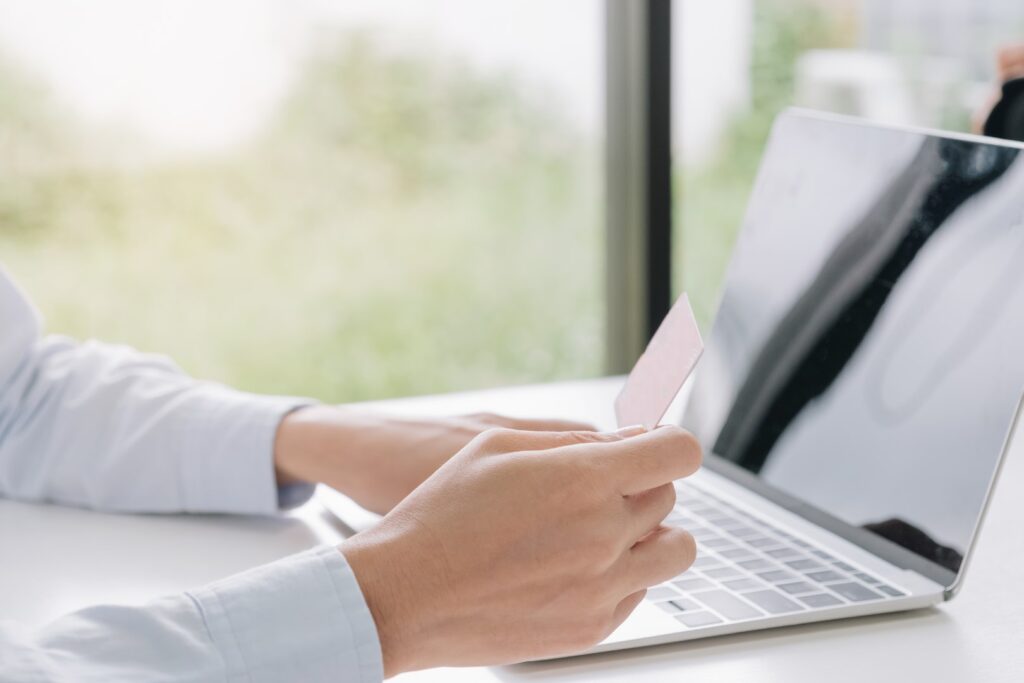 Adult making purchases online using laptop compute