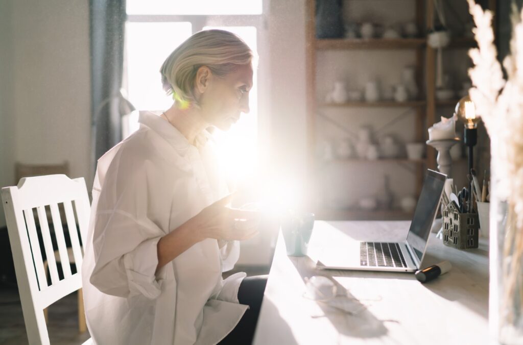Female entrepreneur working at table at art studio