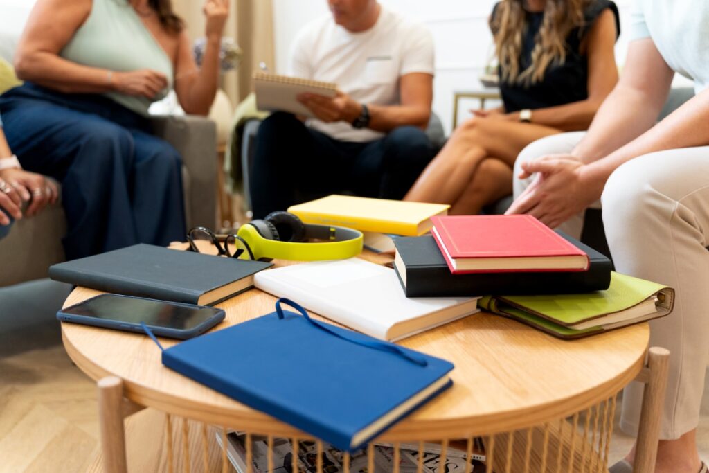 Group gathering around coffee table with books