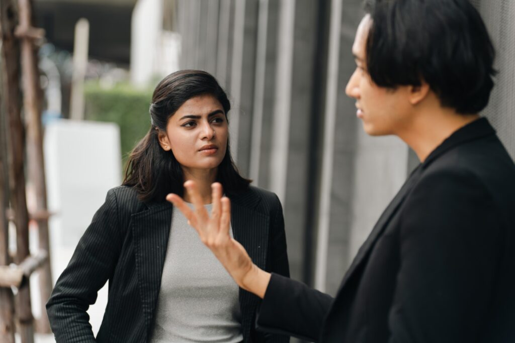 Two professionals having a private workplace conversation