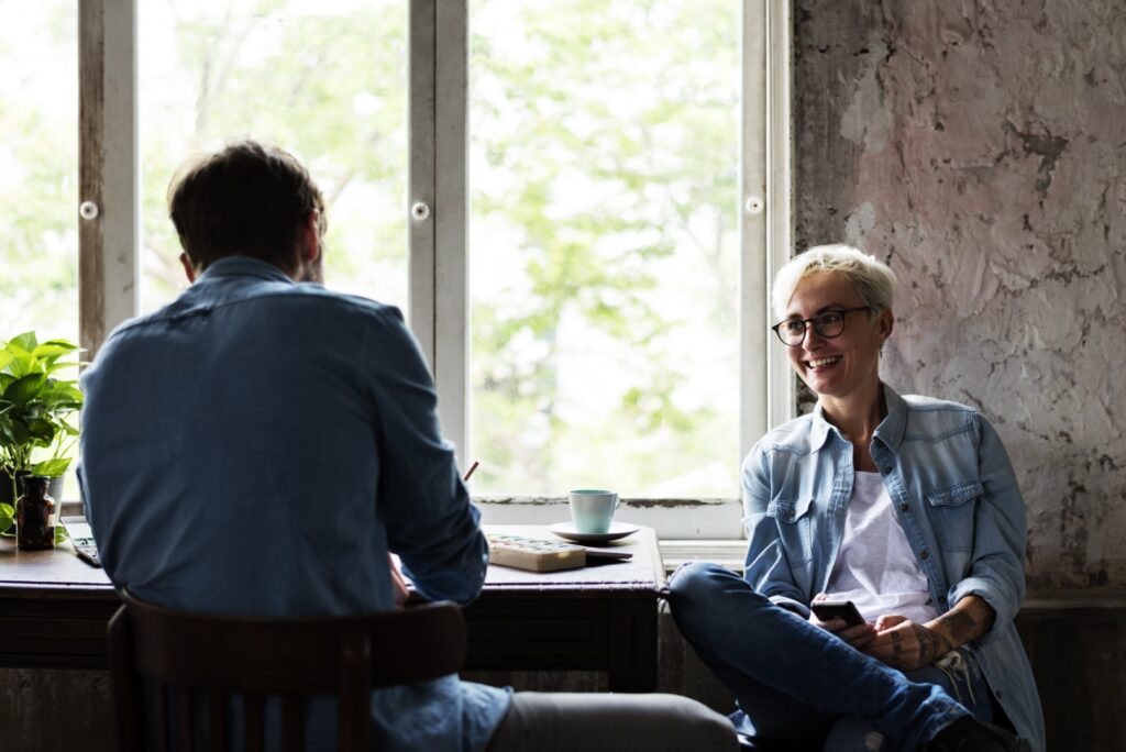 Two people enjoying coffee and conversation indoor
