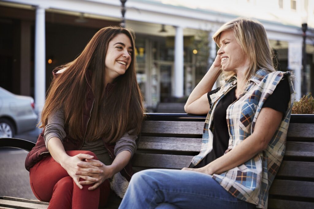 Two women enjoying conversation on a bench