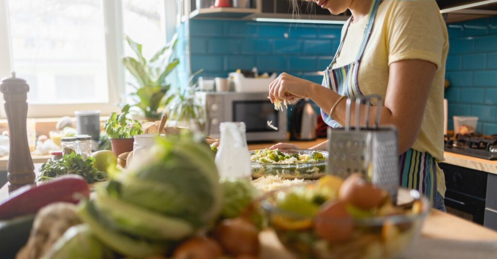 Woman prepares fresh meal in sunny kitchen
