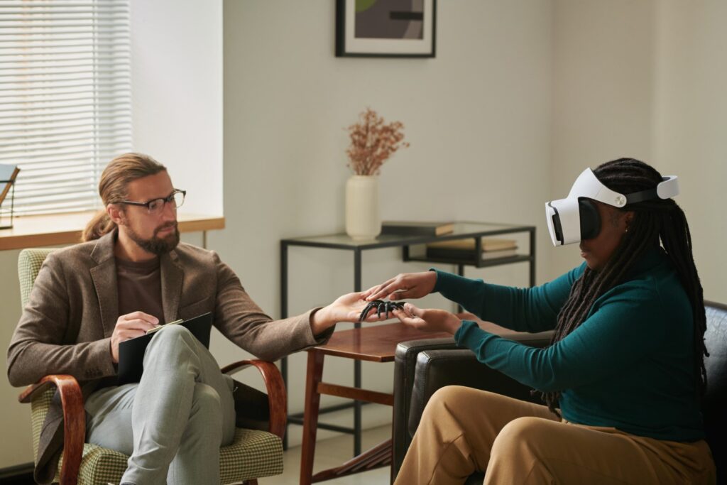 Woman using vr for therapy with consultant present
