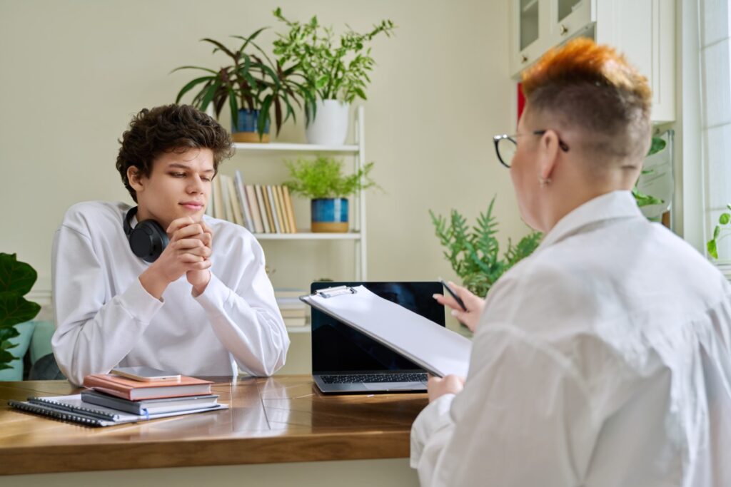 Young male patient in therapy with psychologist co