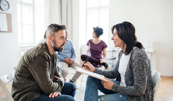 a man in his 60s with a psychologist during Partial Hospitalization Program